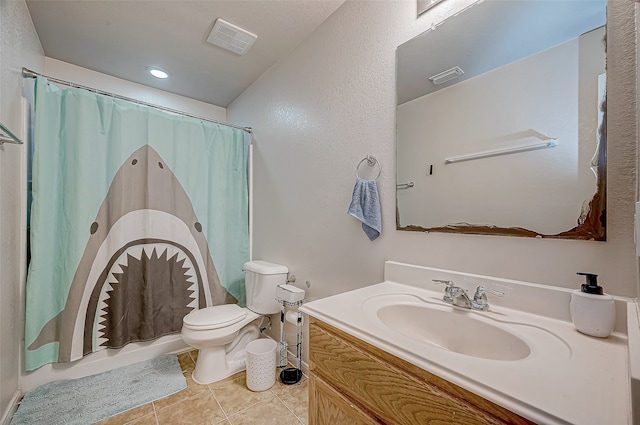 bathroom with toilet, vanity, tile patterned floors, and walk in shower