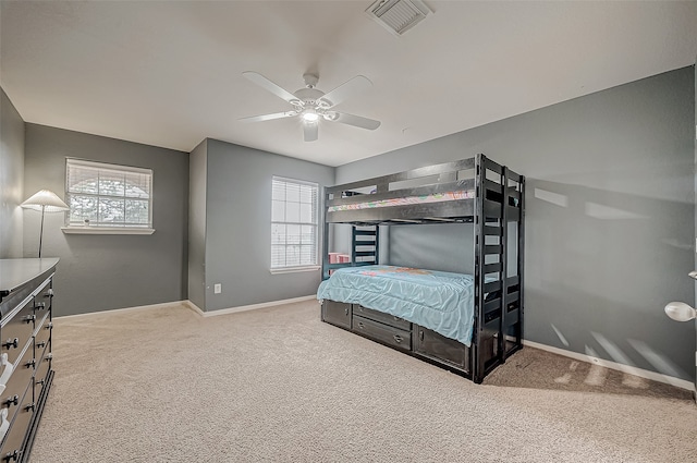 bedroom featuring carpet flooring, multiple windows, and ceiling fan