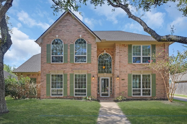 colonial inspired home with a front lawn