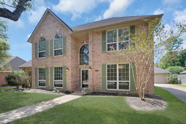 colonial inspired home with a front yard