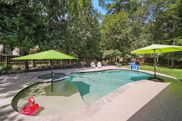 view of pool with a patio area and an in ground hot tub