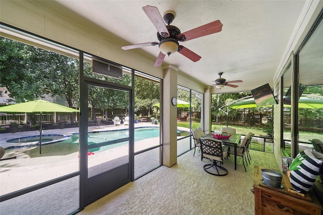 sunroom / solarium featuring ceiling fan