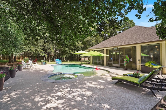 view of swimming pool with a patio area and an in ground hot tub