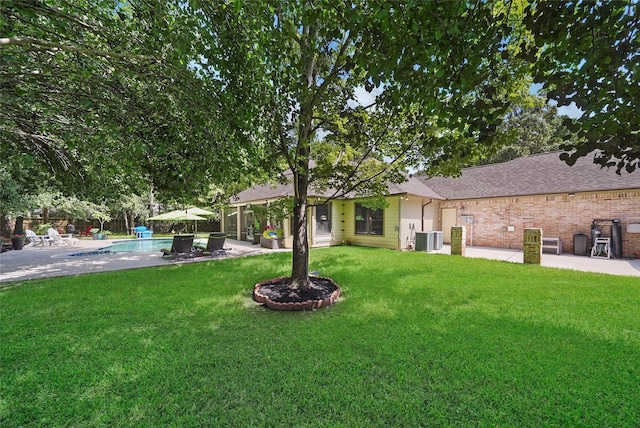 view of yard featuring central AC and a patio