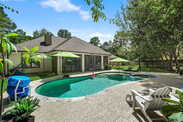 view of pool with a sunroom, an in ground hot tub, and a patio