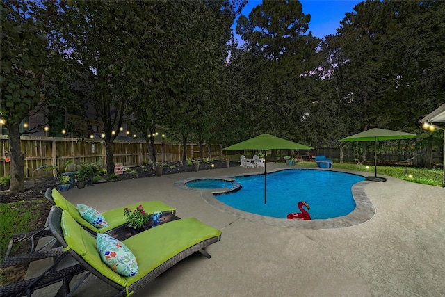 view of pool featuring an in ground hot tub and a patio