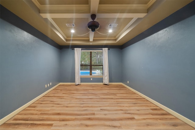 empty room with beam ceiling, crown molding, and light hardwood / wood-style flooring