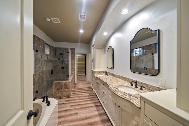 bathroom with vanity, hardwood / wood-style flooring, and separate shower and tub