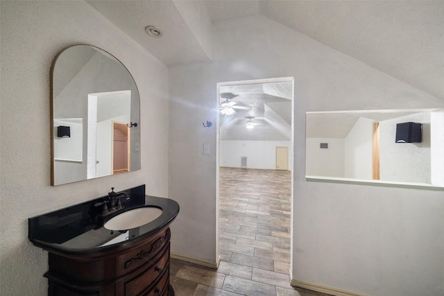 bathroom with vanity, ceiling fan, and lofted ceiling