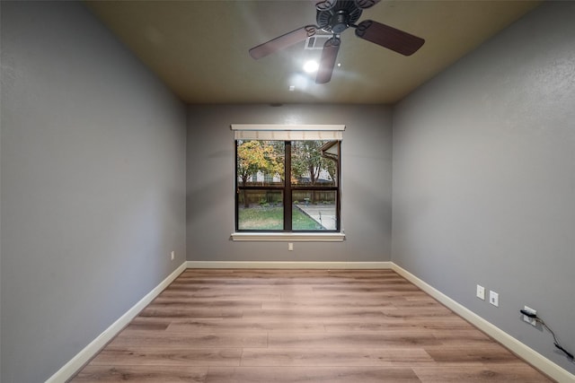 empty room with light wood-type flooring and ceiling fan