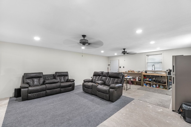 carpeted living room with ceiling fan and sink