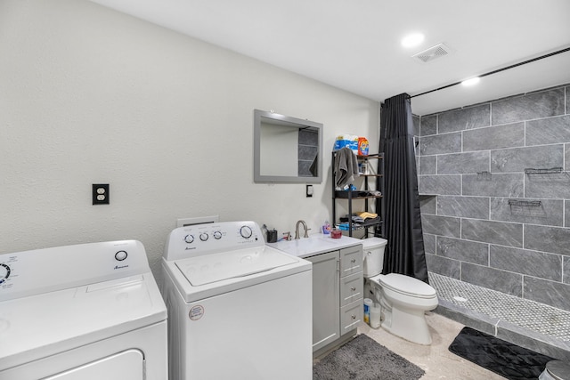 laundry room with separate washer and dryer and sink