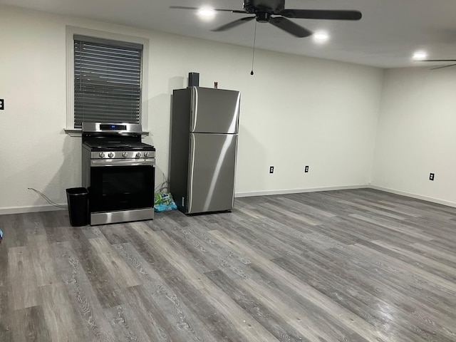 kitchen featuring stainless steel appliances, wood-type flooring, and ceiling fan