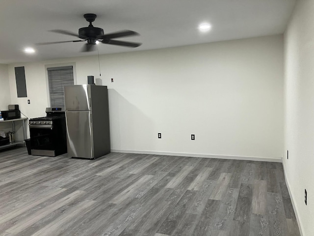 kitchen featuring ceiling fan, appliances with stainless steel finishes, and light hardwood / wood-style flooring