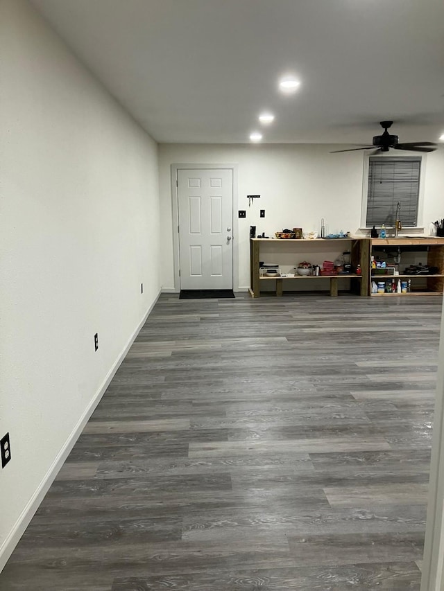 interior space with wood-type flooring, ceiling fan, and a workshop area