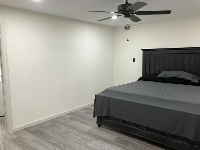 bedroom with ceiling fan and light wood-type flooring