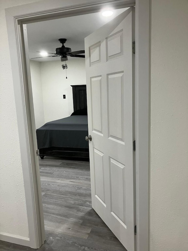 unfurnished bedroom featuring dark hardwood / wood-style flooring and ceiling fan