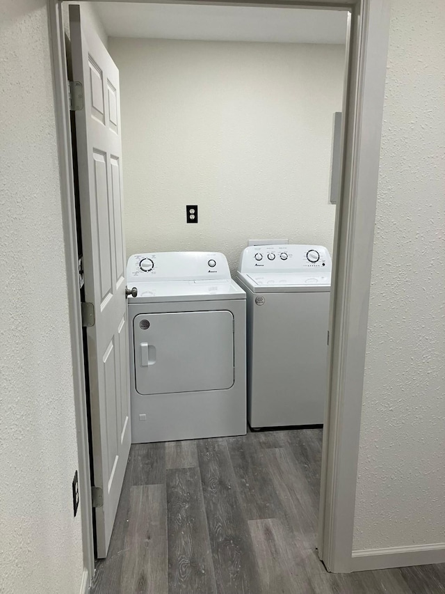 laundry room with dark wood-type flooring and washing machine and clothes dryer