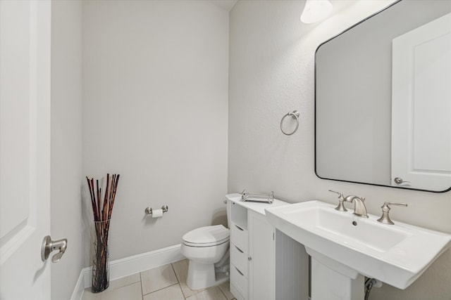 bathroom featuring tile patterned floors, toilet, and sink