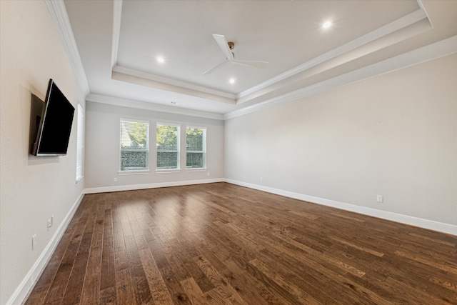 unfurnished living room featuring a raised ceiling, crown molding, dark hardwood / wood-style flooring, and ceiling fan