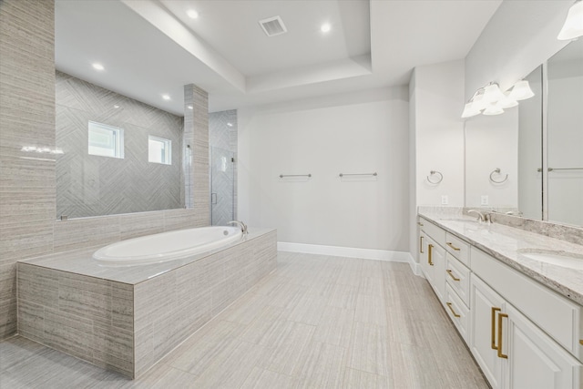 bathroom featuring vanity and separate shower and tub