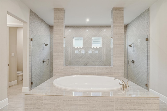 bathroom with tile patterned flooring, separate shower and tub, and toilet