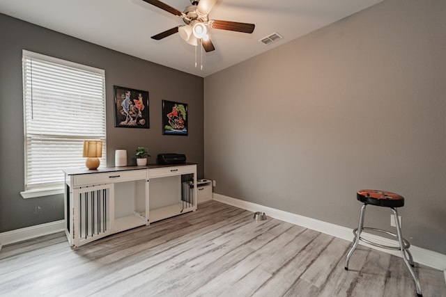 home office featuring ceiling fan and light hardwood / wood-style flooring