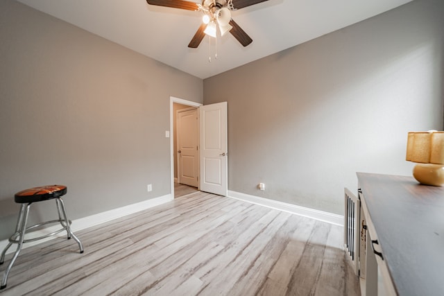 unfurnished bedroom with ceiling fan and light hardwood / wood-style floors