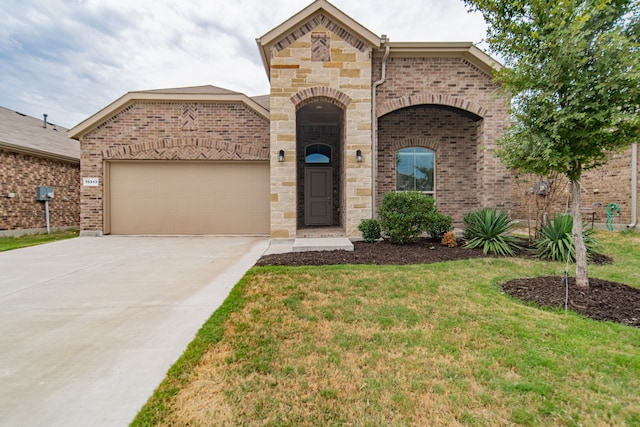 view of front of house with a garage and a front lawn