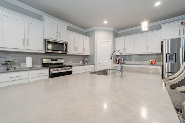 kitchen featuring decorative backsplash, white cabinetry, sink, and stainless steel appliances