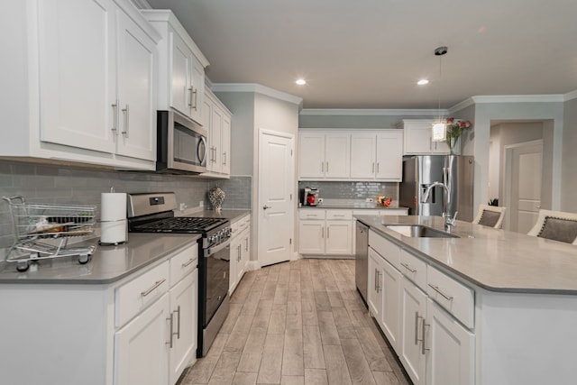 kitchen featuring white cabinetry, sink, light hardwood / wood-style flooring, and appliances with stainless steel finishes