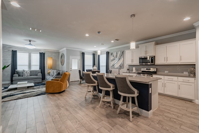 kitchen featuring white cabinetry, pendant lighting, and appliances with stainless steel finishes