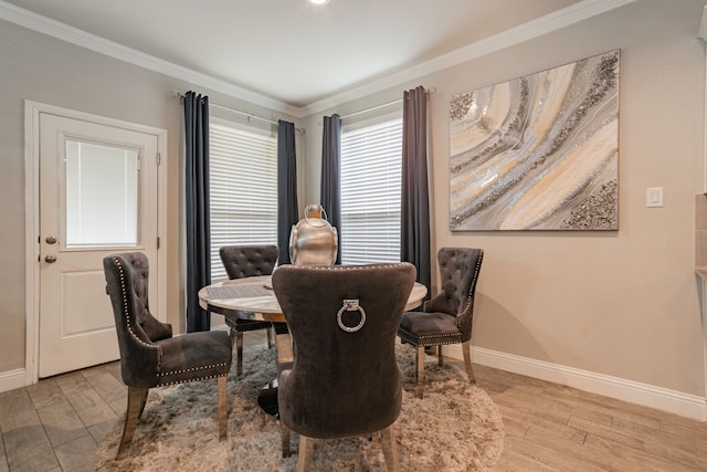 dining room featuring light wood-type flooring and ornamental molding