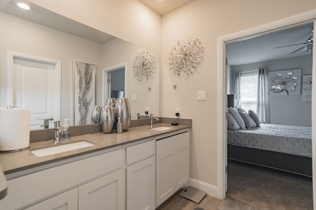 bathroom with hardwood / wood-style flooring, vanity, and ceiling fan