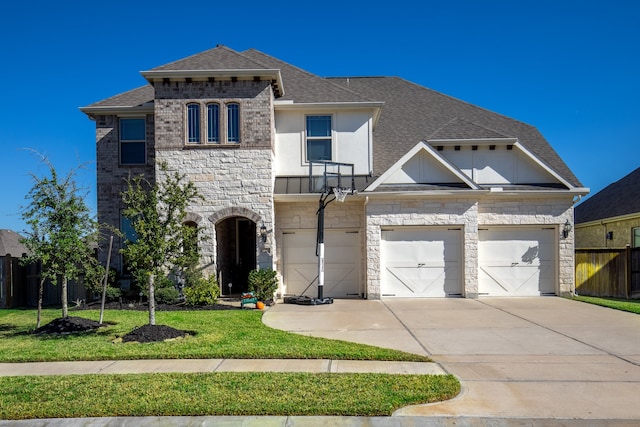 view of front of property with a front yard and a garage