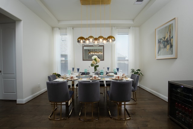 dining area featuring a healthy amount of sunlight, dark hardwood / wood-style flooring, and wine cooler