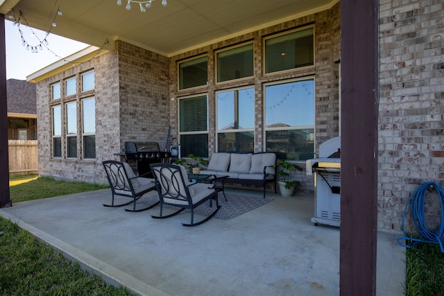 view of patio with an outdoor living space and a grill