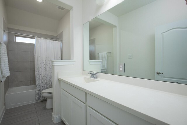 full bathroom with shower / bath combination with curtain, vanity, toilet, and tile patterned floors