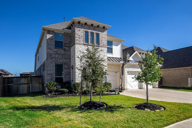 view of front of home featuring a front yard and a garage