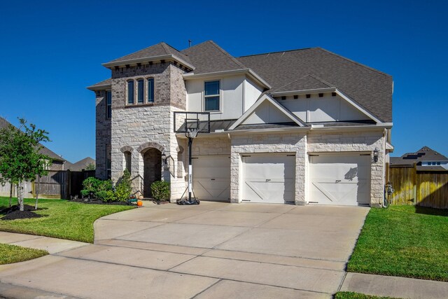 view of front of property with a front yard and a garage