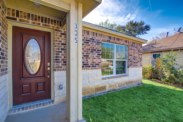 property entrance with a yard