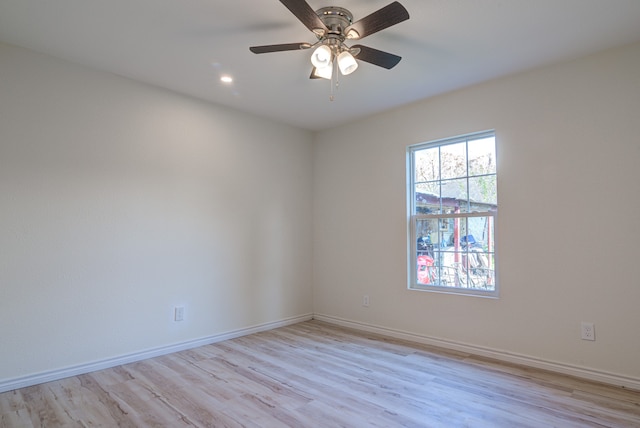 spare room featuring ceiling fan and light hardwood / wood-style flooring