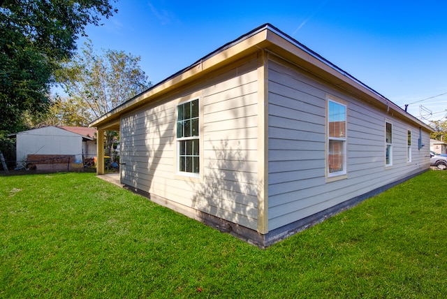 view of side of property with a yard