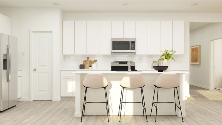 kitchen featuring light hardwood / wood-style floors, white cabinetry, a kitchen island with sink, and appliances with stainless steel finishes