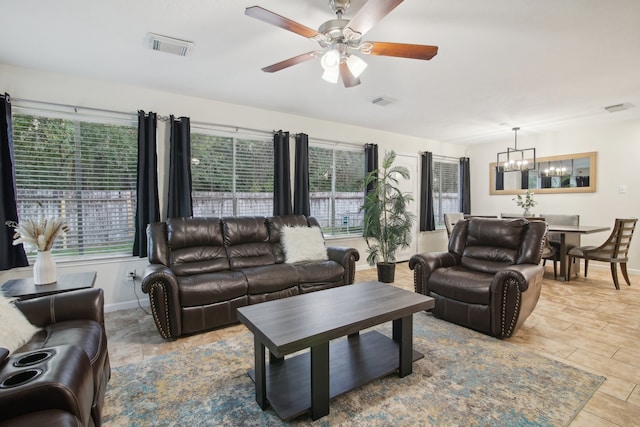 living room featuring plenty of natural light, light hardwood / wood-style floors, and ceiling fan with notable chandelier