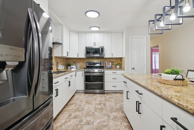 kitchen featuring backsplash, white cabinetry, stainless steel appliances, and hanging light fixtures