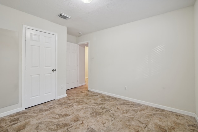 unfurnished bedroom featuring a textured ceiling