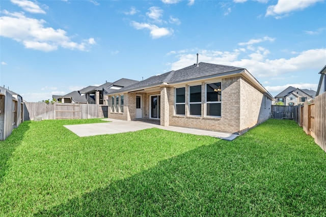 rear view of house featuring a patio area and a lawn