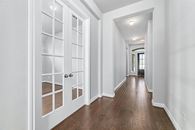 hallway with french doors and dark wood-type flooring