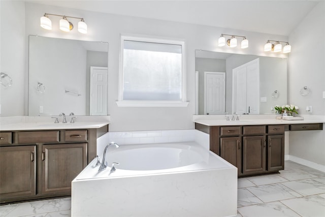 bathroom with vanity and a tub